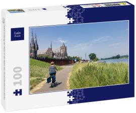 Lais Puzzle - Frau radelt entlang der Maas in der Nähe des niederländischen Dorfes Cuijk - 100 Teile